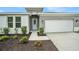 Welcoming front entrance with a light blue door and manicured landscaping at 9955 Patrician Dr, New Port Richey, FL 34655