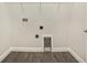 Spacious laundry room boasts sleek wood-look flooring and convenient utility hookups at 9955 Patrician Dr, New Port Richey, FL 34655