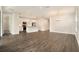 Open-concept living room with hardwood floors seamlessly connects to the kitchen at 9955 Patrician Dr, New Port Richey, FL 34655