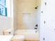 Bright bathroom featuring a toilet and tiled tub/shower combination at 14073 Naylor Ave, Port Charlotte, FL 33981