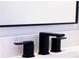 Sleek, modern black bathroom faucet on a white marble countertop at 14073 Naylor Ave, Port Charlotte, FL 33981