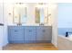 Bathroom featuring double vanity sinks, decorative mirrors, and modern fixtures at 14073 Naylor Ave, Port Charlotte, FL 33981