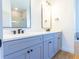 Modern bathroom with double vanity sinks, quartz countertops, and decorative mirrors at 14073 Naylor Ave, Port Charlotte, FL 33981