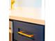 Close up of gold hardware on modern, soft close kitchen cabinets with quartz countertop at 14073 Naylor Ave, Port Charlotte, FL 33981