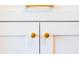 Elegant white cabinets are accented with sleek, gold hardware at 14073 Naylor Ave, Port Charlotte, FL 33981