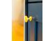 Close up of a round, gold kitchen cabinet knob featured in a modern home at 14073 Naylor Ave, Port Charlotte, FL 33981
