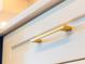Modern kitchen cabinet featuring a sleek, minimalist pull handle in a complementary gold finish at 14073 Naylor Ave, Port Charlotte, FL 33981