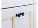 Close-up view of the cabinetry featuring recessed doors with sleek, round, black hardware at 14073 Naylor Ave, Port Charlotte, FL 33981