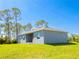 Expansive backyard view showcasing the spacious lawn and the home's exterior at 14073 Naylor Ave, Port Charlotte, FL 33981