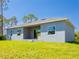Rear exterior of home with covered lanai and large back yard at 14073 Naylor Ave, Port Charlotte, FL 33981
