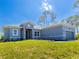 Charming single-story home with a well-manicured lawn, gray brick driveway, and an attached two-car garage at 14073 Naylor Ave, Port Charlotte, FL 33981