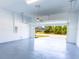 Bright two-car garage with epoxy flooring, and a view to the exterior at 14073 Naylor Ave, Port Charlotte, FL 33981
