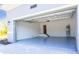 Spacious two-car garage with a sealed gray floor with an access door and water heater on the back wall at 14073 Naylor Ave, Port Charlotte, FL 33981
