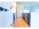 Kitchen featuring navy cabinets, stainless steel appliances, and an open view to the living space at 14073 Naylor Ave, Port Charlotte, FL 33981