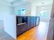 Modern kitchen island with dark cabinets, gold hardware, quartz countertops, and stainless steel appliances at 14073 Naylor Ave, Port Charlotte, FL 33981