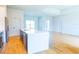 Modern kitchen with an island, white countertops, wood tile flooring, and stainless steel appliances at 14073 Naylor Ave, Port Charlotte, FL 33981