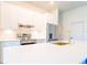 Bright kitchen featuring white cabinets, stainless steel appliances, quartz countertops, and a gold faucet at 14073 Naylor Ave, Port Charlotte, FL 33981