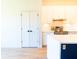 Bright kitchen features white cabinets, stainless steel appliances, and wood look flooring at 14073 Naylor Ave, Port Charlotte, FL 33981