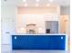 Modern kitchen featuring an island with white countertops, stainless steel appliances, and white cabinets at 14073 Naylor Ave, Port Charlotte, FL 33981