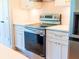New stainless steel range oven in a modern kitchen with white cabinets and gold hardware at 14073 Naylor Ave, Port Charlotte, FL 33981