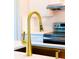 Close up on a golden faucet with a black sink and stainless steel appliances in the background at 14073 Naylor Ave, Port Charlotte, FL 33981