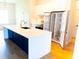 Bright, modern kitchen with a large island, stainless steel appliances, and sleek white cabinetry at 14073 Naylor Ave, Port Charlotte, FL 33981
