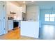 Bright kitchen featuring stainless steel appliances, white cabinets, an island, and wood tile flooring at 14073 Naylor Ave, Port Charlotte, FL 33981