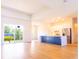 Open floor plan with wood tile flooring, natural light, and a spacious modern kitchen at 14073 Naylor Ave, Port Charlotte, FL 33981