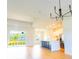 Open-concept living room featuring wood floors, bright lighting, and views of the kitchen at 14073 Naylor Ave, Port Charlotte, FL 33981