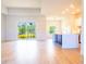 Open-concept living room showcasing wood floors, a large window, and a kitchen with an island at 14073 Naylor Ave, Port Charlotte, FL 33981