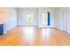 Bright, open living room with wood tile floors, a modern chandelier, and natural light at 14073 Naylor Ave, Port Charlotte, FL 33981
