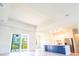 Open-concept living space with lots of natural light, a modern kitchen, and access to the backyard at 14073 Naylor Ave, Port Charlotte, FL 33981