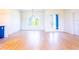 Spacious living space featuring wood-look flooring and a modern light fixture at 14073 Naylor Ave, Port Charlotte, FL 33981