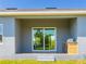 Covered patio with built in outdoor kitchen and sliding glass doors at 14073 Naylor Ave, Port Charlotte, FL 33981