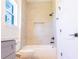 Shower and tub with neutral tiling and storage nook at 14073 Naylor Ave, Port Charlotte, FL 33981