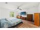 Comfortable bedroom with wood floors, ceiling fan, and natural light at 15364 Mount Sparrow Rd, Weeki Wachee, FL 34614