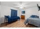 Bedroom featuring wood floors, window, ceiling fan and TV at 15364 Mount Sparrow Rd, Weeki Wachee, FL 34614