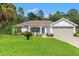 Charming single-story home with lush lawn and a two-car garage at 15364 Mount Sparrow Rd, Weeki Wachee, FL 34614