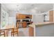 Bright kitchen features tile flooring, stainless steel appliances, a breakfast bar, and wooden cabinetry at 15364 Mount Sparrow Rd, Weeki Wachee, FL 34614
