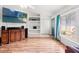 Bright living room with wood floors, built-in shelves, and large window at 15364 Mount Sparrow Rd, Weeki Wachee, FL 34614