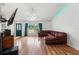 Spacious living area with modern flooring and comfortable leather sectional at 15364 Mount Sparrow Rd, Weeki Wachee, FL 34614