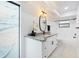 Modern bathroom featuring a white vanity with granite countertop and black fixtures at 2556 Arborwood Dr, Valrico, FL 33596