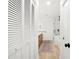Bright bathroom featuring a walk-in shower with glass enclosure, wood floors, and closet for storage at 2556 Arborwood Dr, Valrico, FL 33596