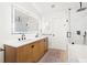 Modern bathroom featuring double sinks, wood cabinets, quartz countertops, and a large glass shower at 2556 Arborwood Dr, Valrico, FL 33596