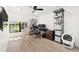 Bright bedroom features hardwood floors, a ceiling fan, and a lovely view from the large window at 2556 Arborwood Dr, Valrico, FL 33596