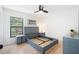 Bedroom with sleek modern blue bed frame, contemporary decor, and a bright window view at 2556 Arborwood Dr, Valrico, FL 33596
