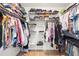Walk-in closet with metal shelving and hanging racks for organized clothing storage at 2556 Arborwood Dr, Valrico, FL 33596