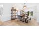 Bright dining space featuring a wooden table, modern chairs, and open shelving for decor at 2556 Arborwood Dr, Valrico, FL 33596