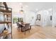 Stylish dining area with a wooden table, modern chairs, a bench, and a large window at 2556 Arborwood Dr, Valrico, FL 33596