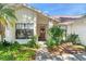 Close-up of the front door with a decorative wreath, surrounded by lush greenery at 2556 Arborwood Dr, Valrico, FL 33596